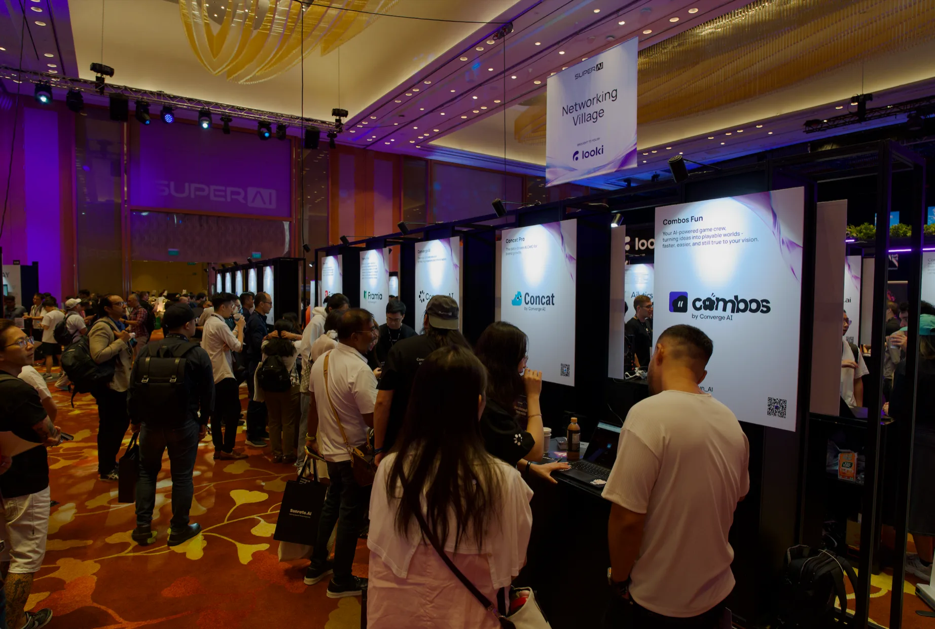 Conversations with visitors at the Converge AI booth